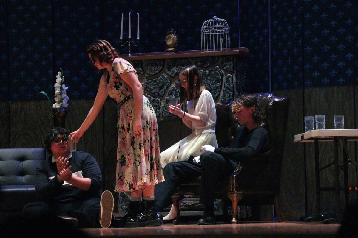Sophomore Ell Norment sits comfortably as Junior Abby Bloss wants glasses of water to Sophomore Jo Greathead and Senior Noah Rahman.