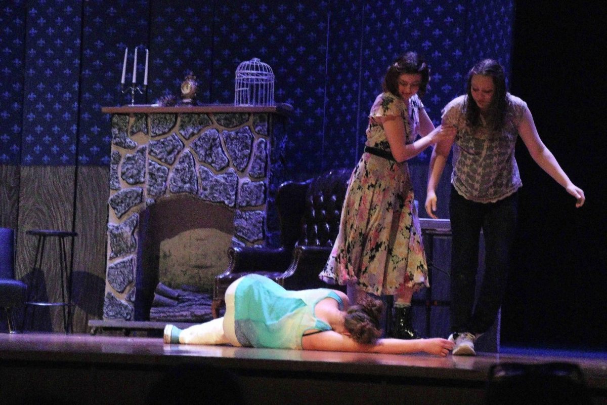 Junior Abby Bloss pulls Freshman Lacey Calhoun away from Junior Claire Keller, who lays dead on the floor.