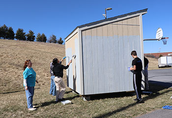 Math teacher Patricia Cloud instructs Volunteers. "If they're going to do it, they got to do it right," said Cloud.
