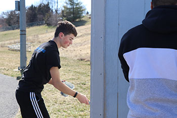 Sophomore Josiah Nafziger paints left shed wall. "Just painting", said Nafziger.