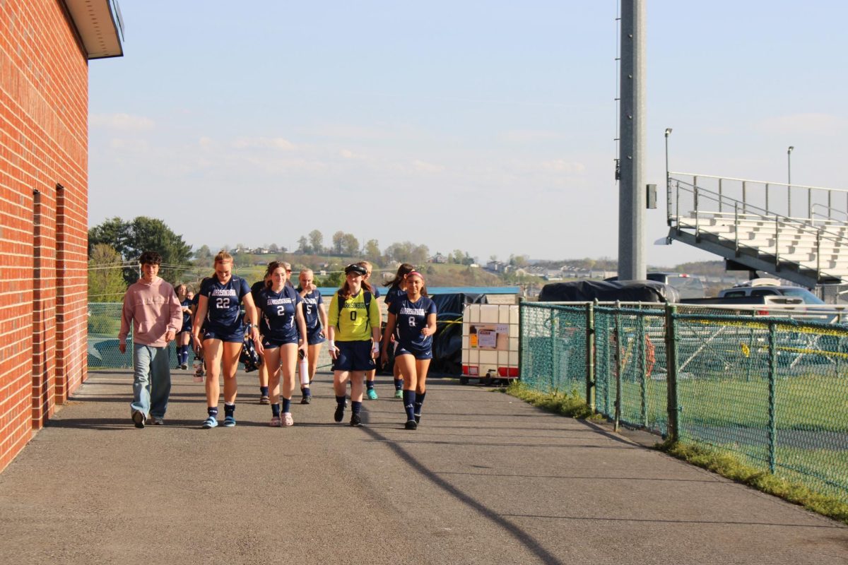 Varsity girls soccer walking to the field.
