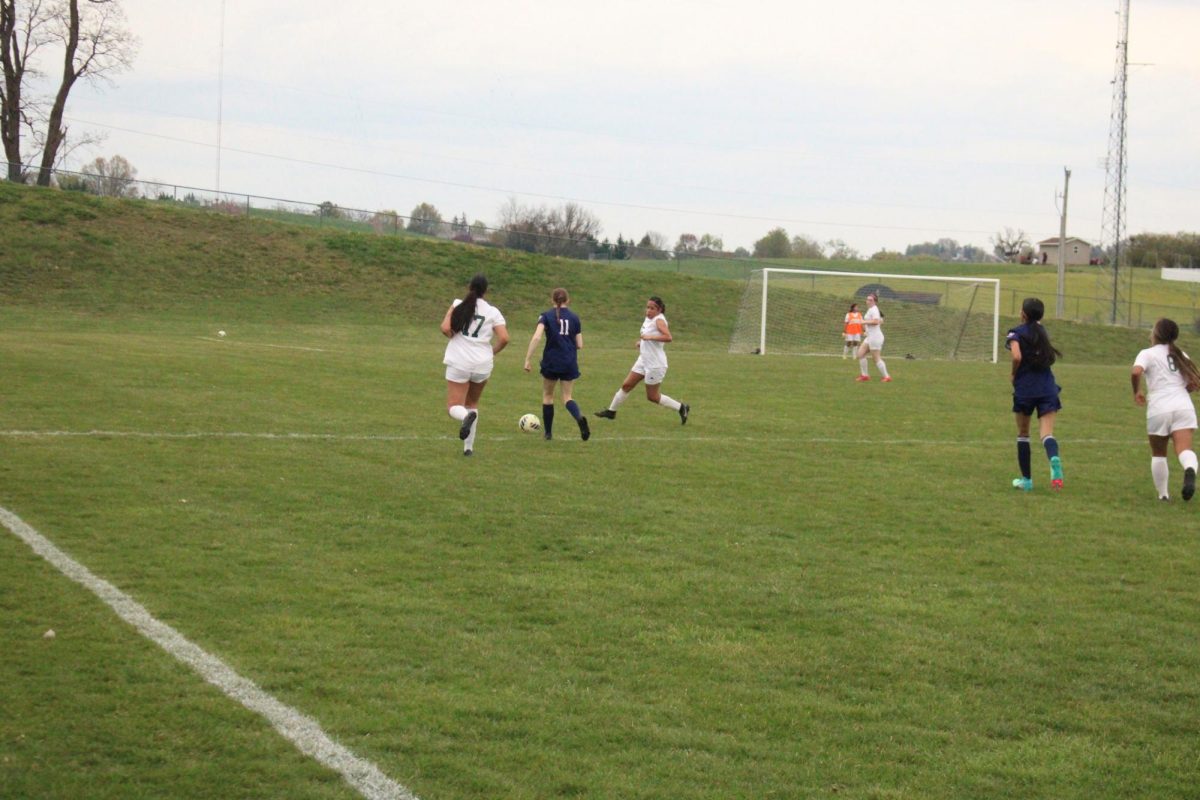 Grace Tysinger keeping the ball away from their opponents.