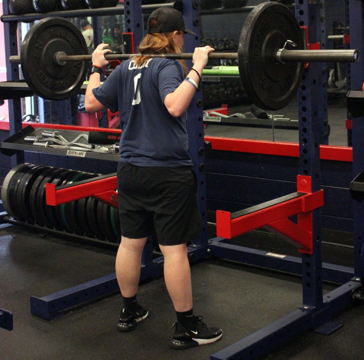Multi-sport athlete Ava Colley is shown doing squats with a weight most people can't do. With football season coming close, she works hard to show off why she deserves a spot on the team.