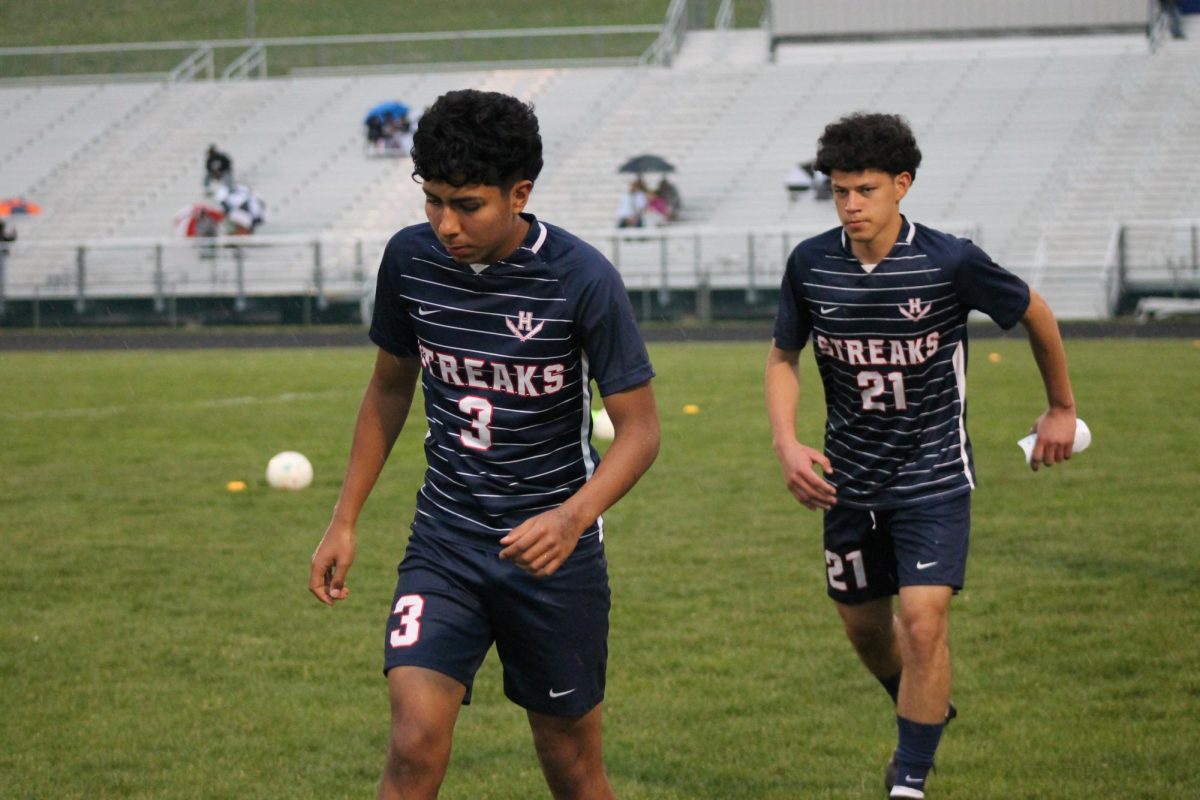 The boys soccer players are seen warming up before the game. 