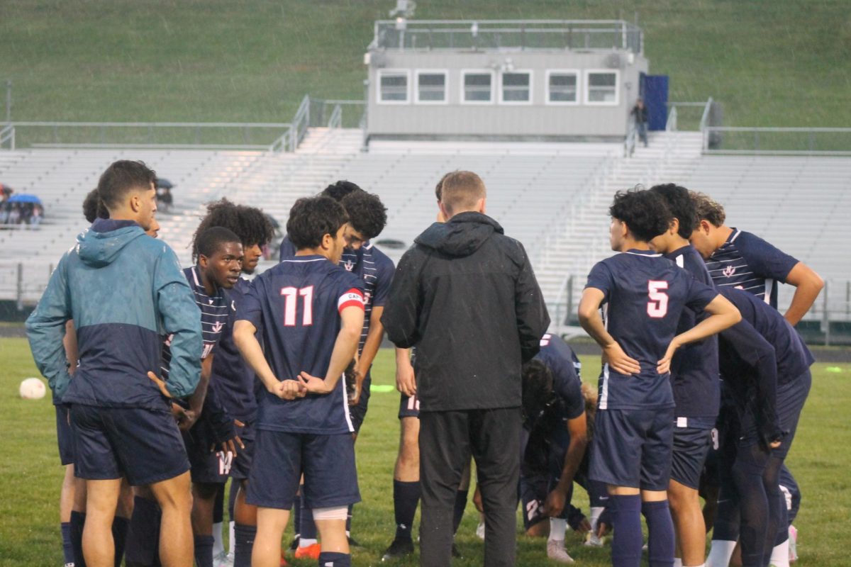 The varsity boys soccer team is dicussing the game during half time. 