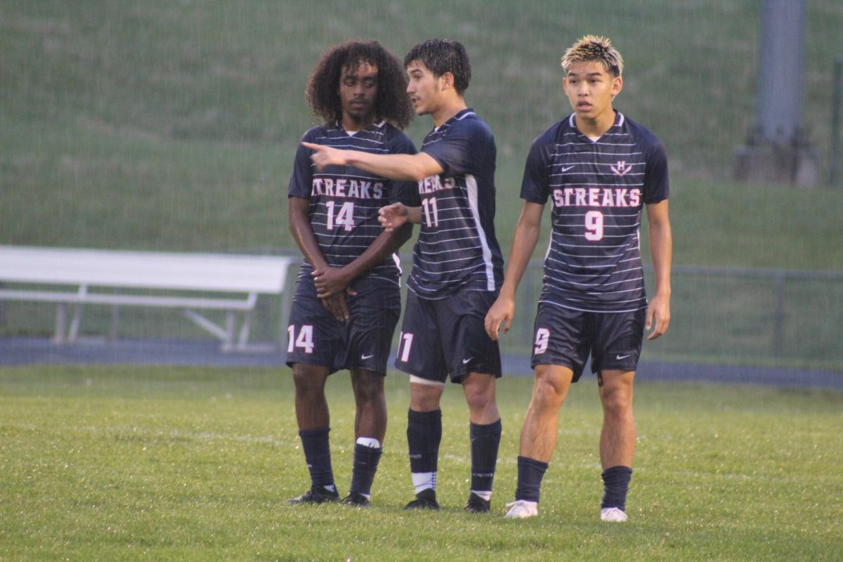 Senior Temesgen Habtemichael, Senior Izaack Cruz, & Edison Rattana prepare for a wall block.