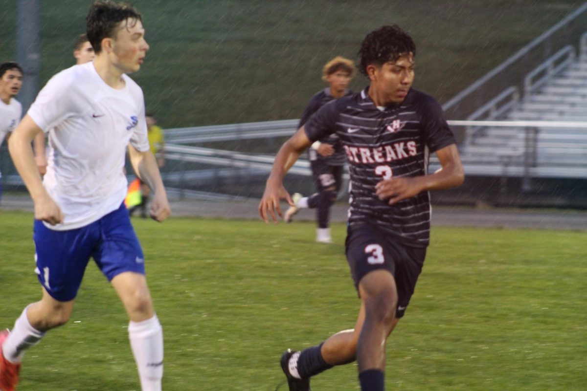 Freshman Alfredo Rivero-Rodriguez intercepts with opponent and ball.