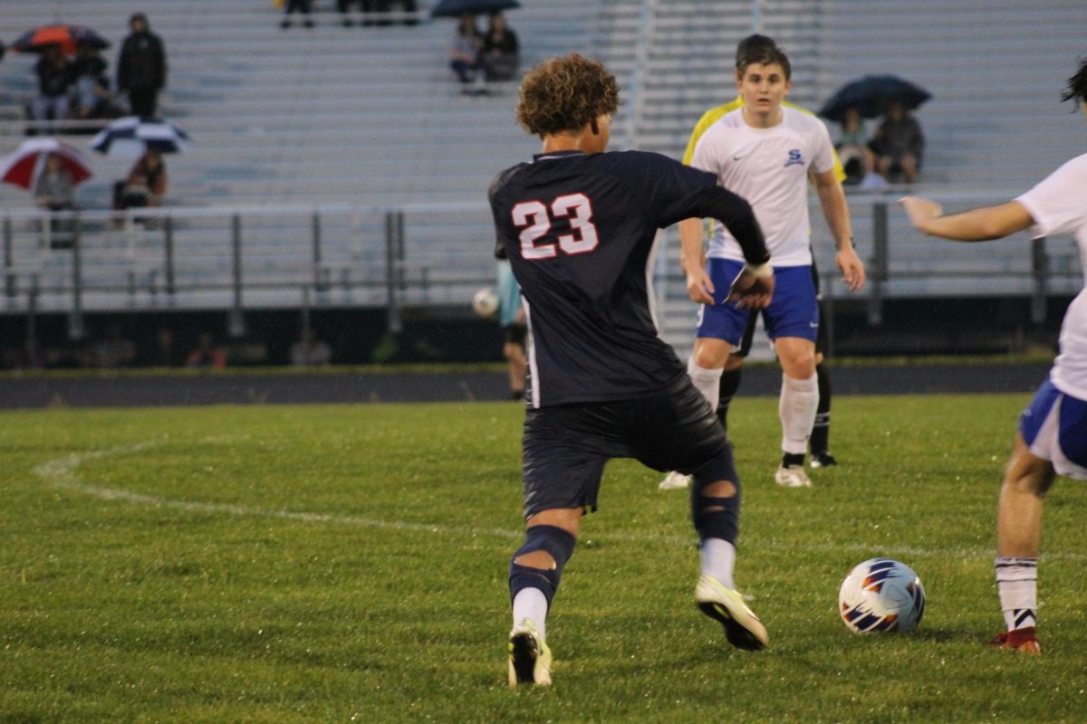 Senior Kaiden Velasquez dribbles the ball around opponent.