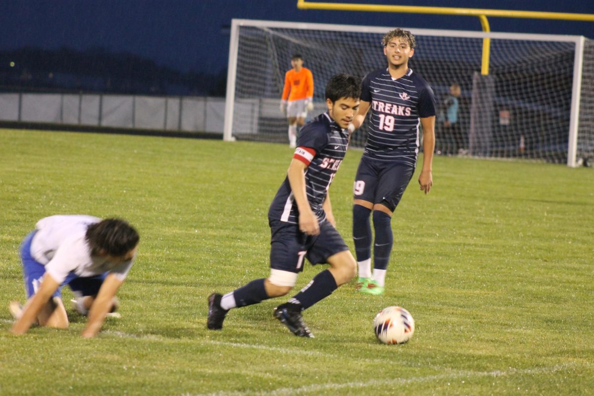  Senior Izaack Gonzalez is taking away the ball from a spootswood player.