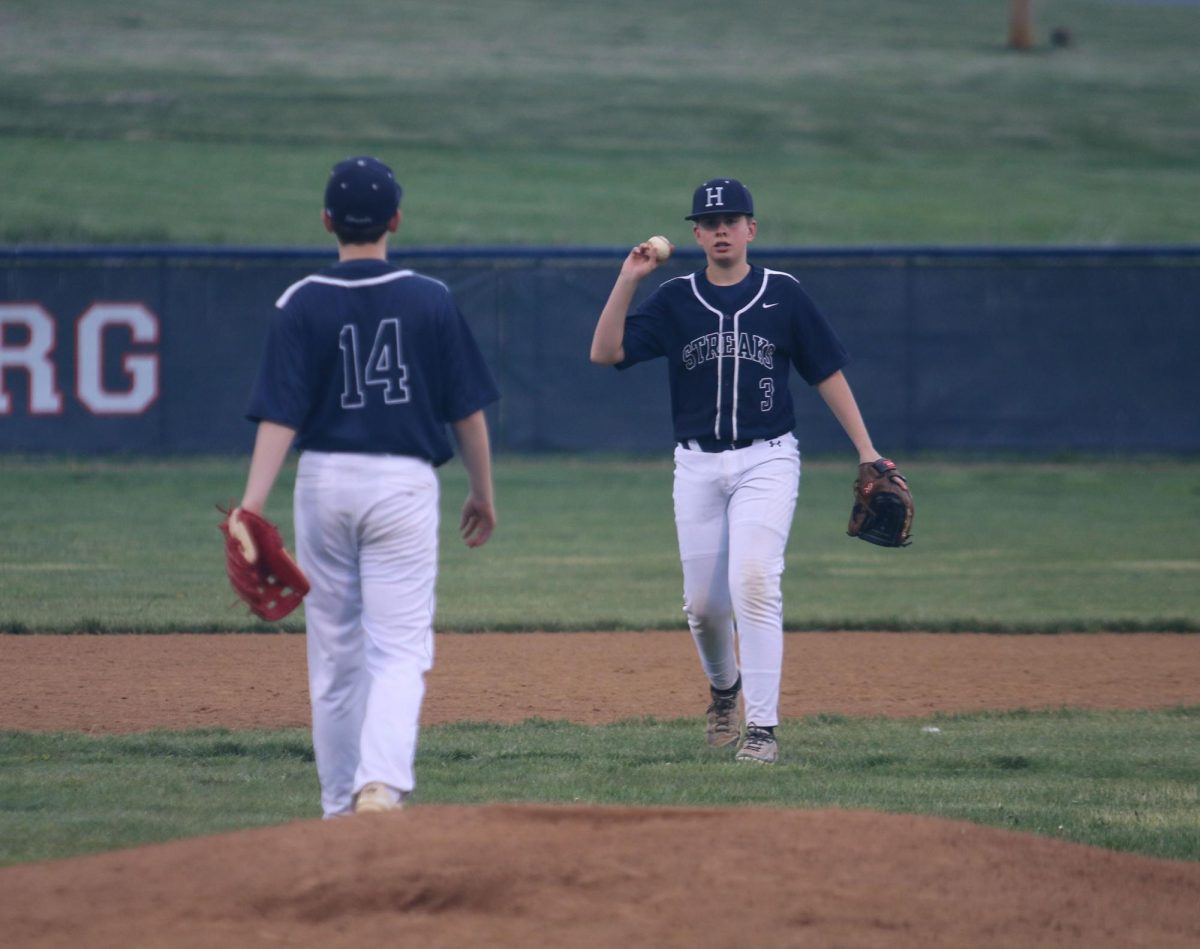 Eighth grader Andrew Noll throws teammate Shea Gibson the ball