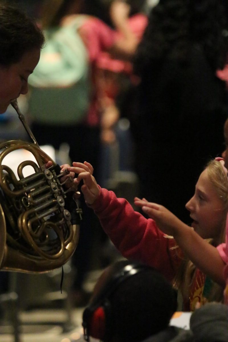 Chloe Starling showing her french horn to the tiny tot students."I am really happy seeing the kids reaction to the french horn."