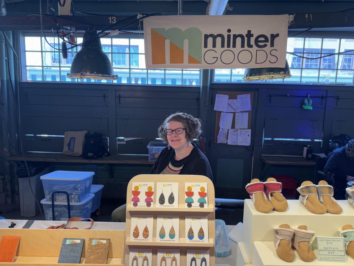Amy Barr, owner of Minter Goods stands in front of her business stall in Pike Place Market. 