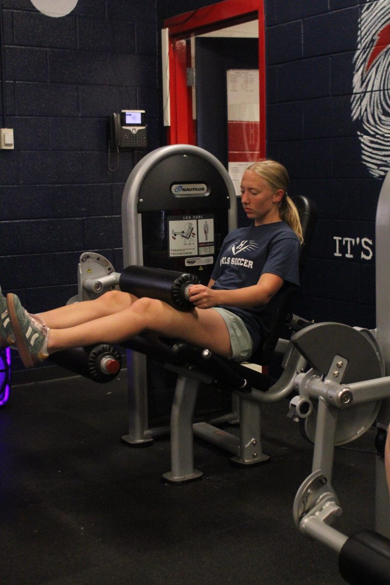 Katie Grace on the leg machine working on her glutes and hamstrings."Lifting has become part of my routine,it's something I genuinely enjoy".