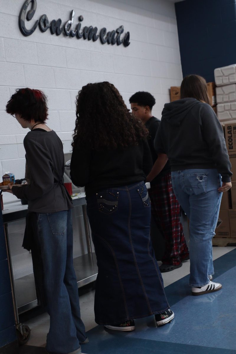 Students getting condiments at lunch.