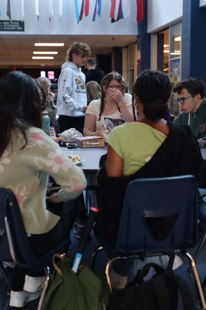 Students laughing and eating lunch.