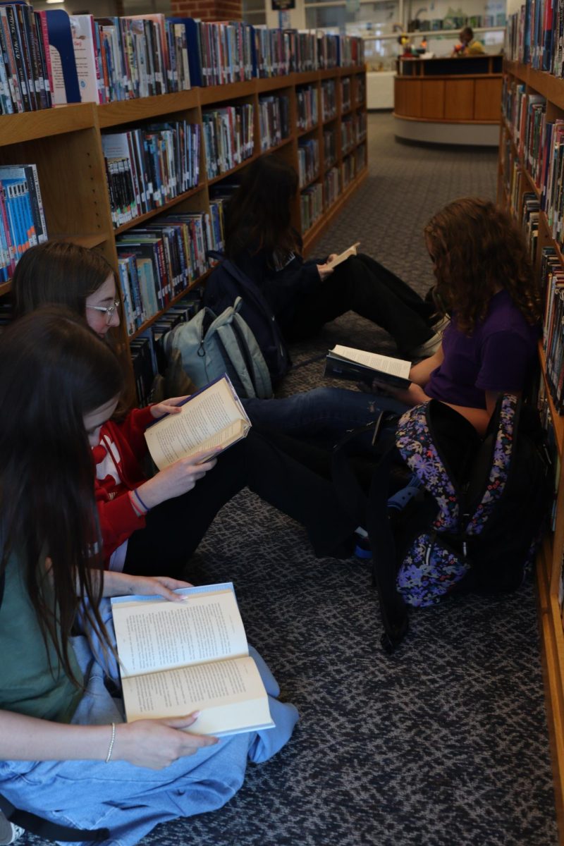 Jillian Carr reading with her friends. "We all are reading the same book so its really fun".
