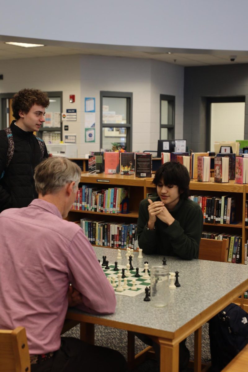 Librarian playing chess with fellow students. "I really like getting to know more students through chess".