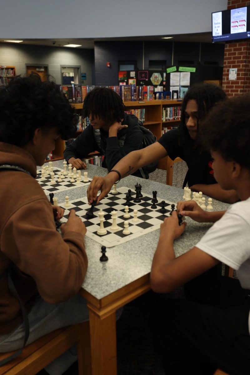 Henry Gilliete watching his friends play chess."We all take turns so its really cool".