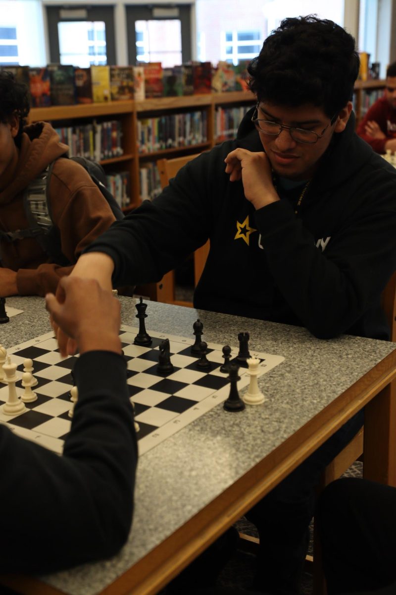 Senior Erik Diaz, playing chess during lunch. "I really think chess helps me get to know students more".