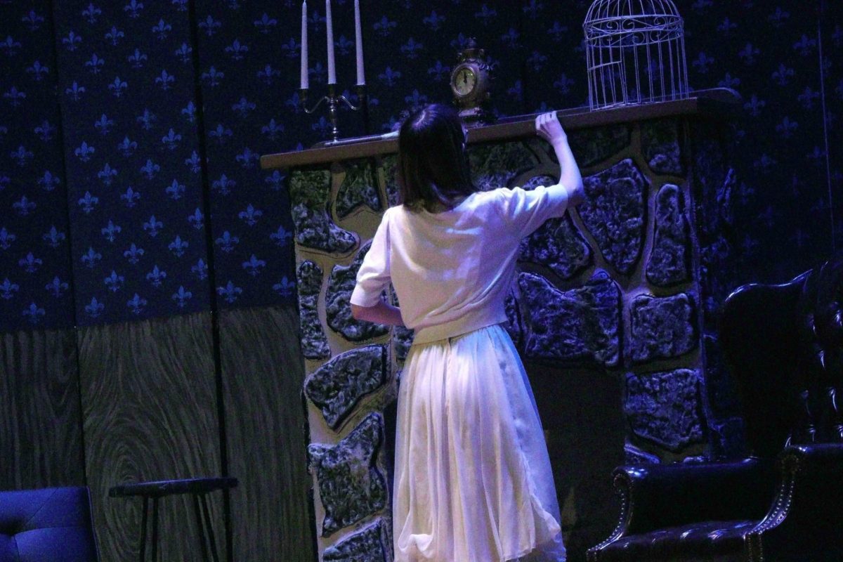 Sophomore Jo Greathead searches around the mansion for something.