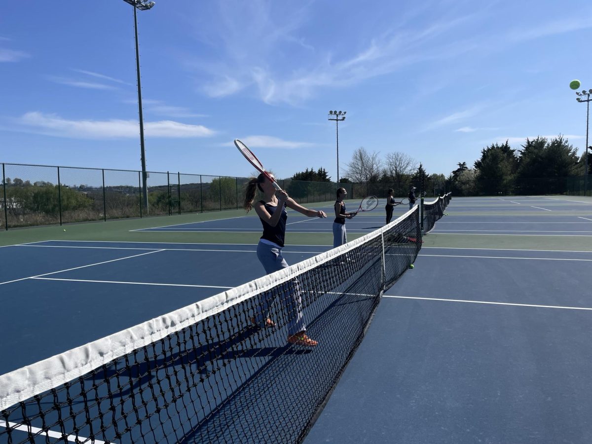 Sophomore Brynn Smith volleys the tennis ball. 