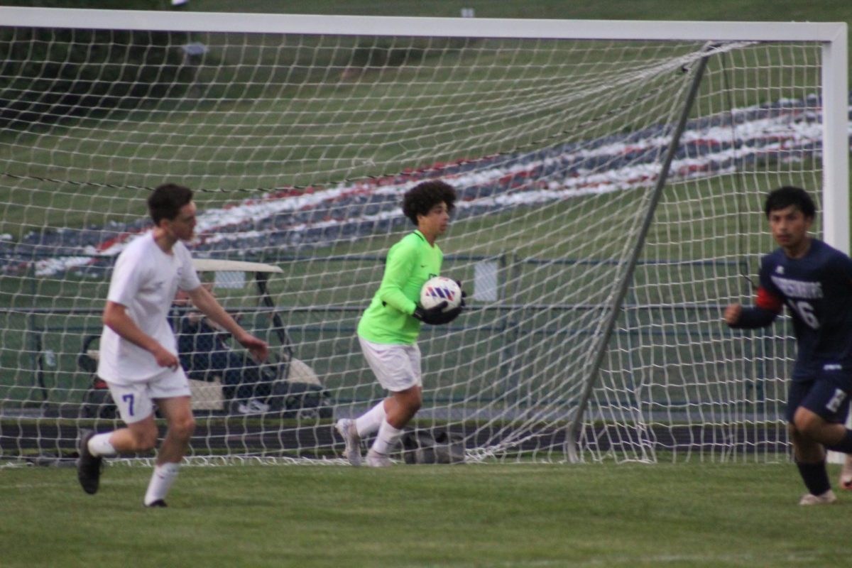 Freshman Goalkeeper Rhett Curtis successfully catches the ball after opponent attempts to score. 