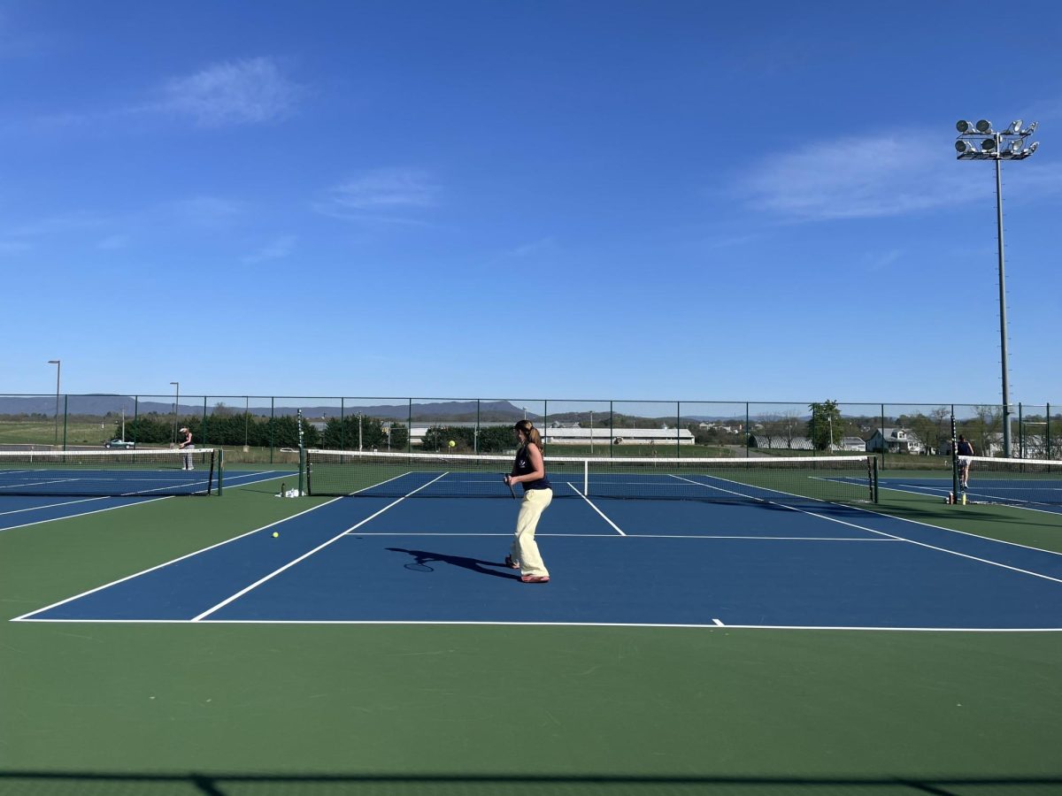 Senior Evelyn Lewis plays against her opponent during her match. 
