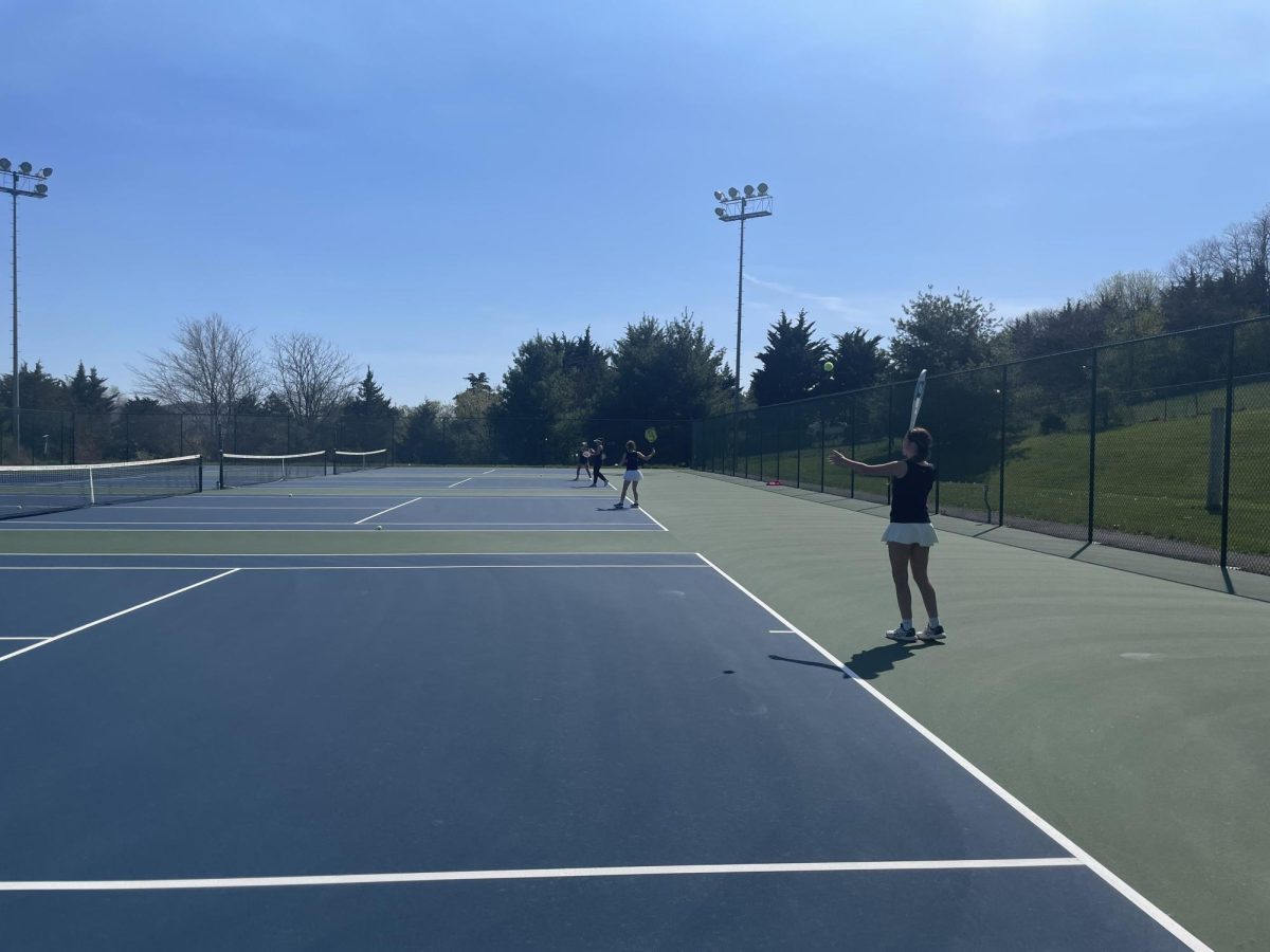 Sophomore Finnly Miller serves to her teammate. 