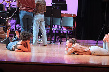 Fine arts students during the roots run deep event as they smile at each other.