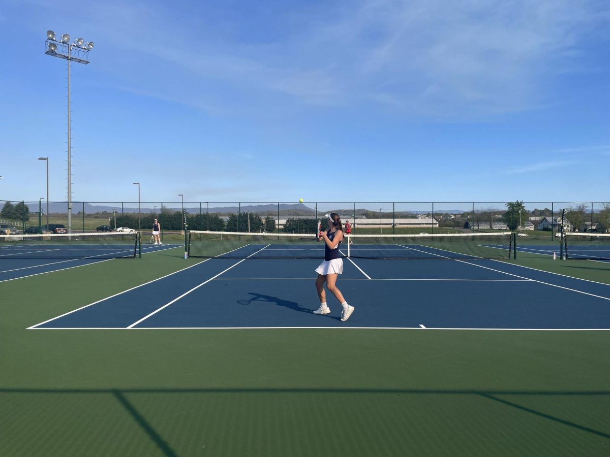 Senior Macy Waid hits with her backhand during a match. 