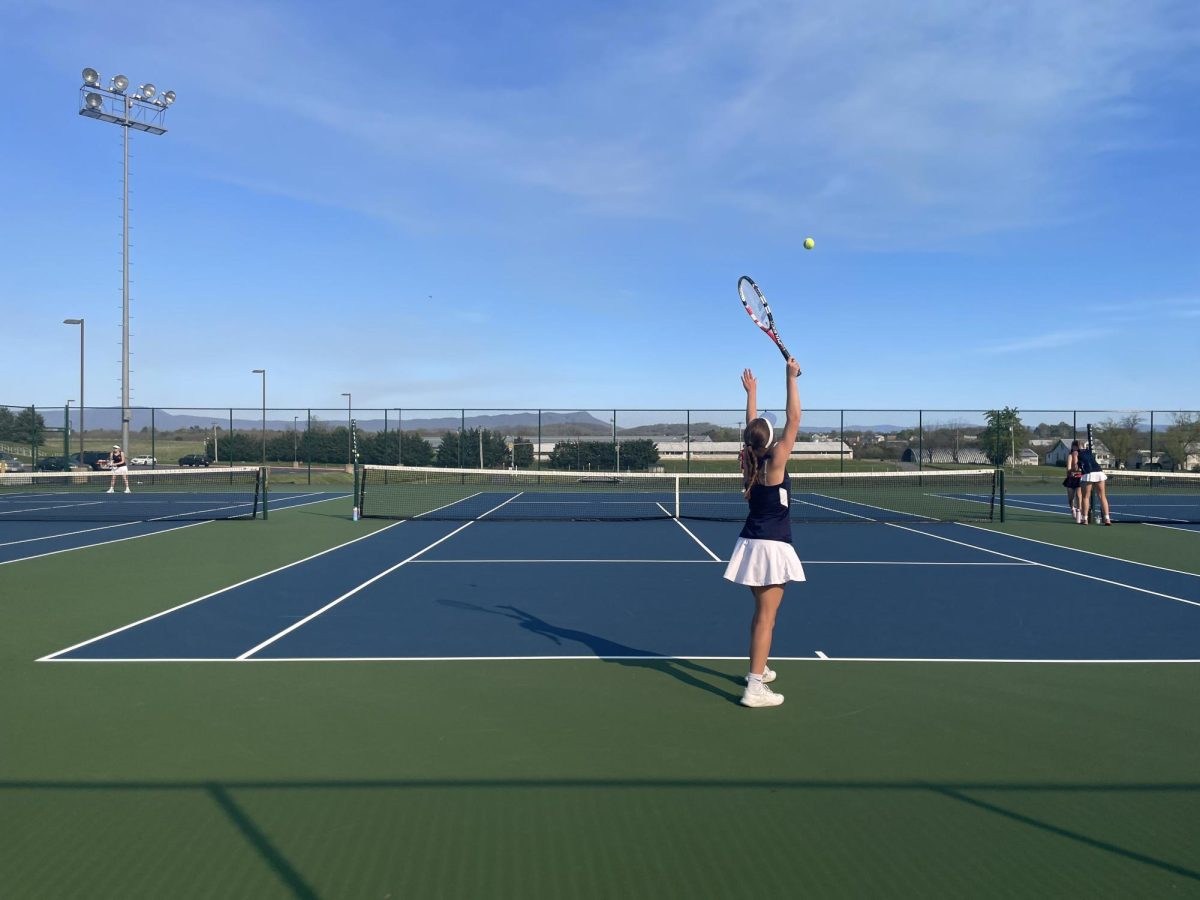 Senior Macy Waid serves the ball to begin the point. 
