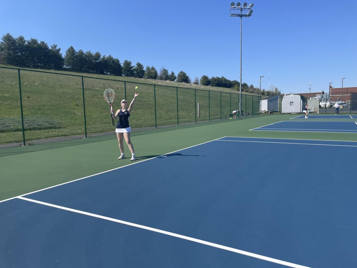 Sophomore Phoenix Seidel serves the ball to her teammate. 