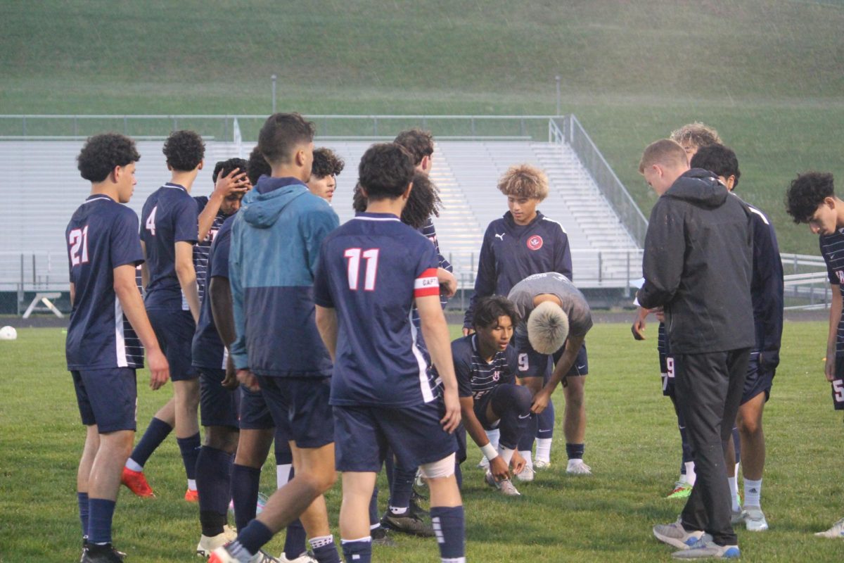 Varsity boys soccer together before the game starts.
