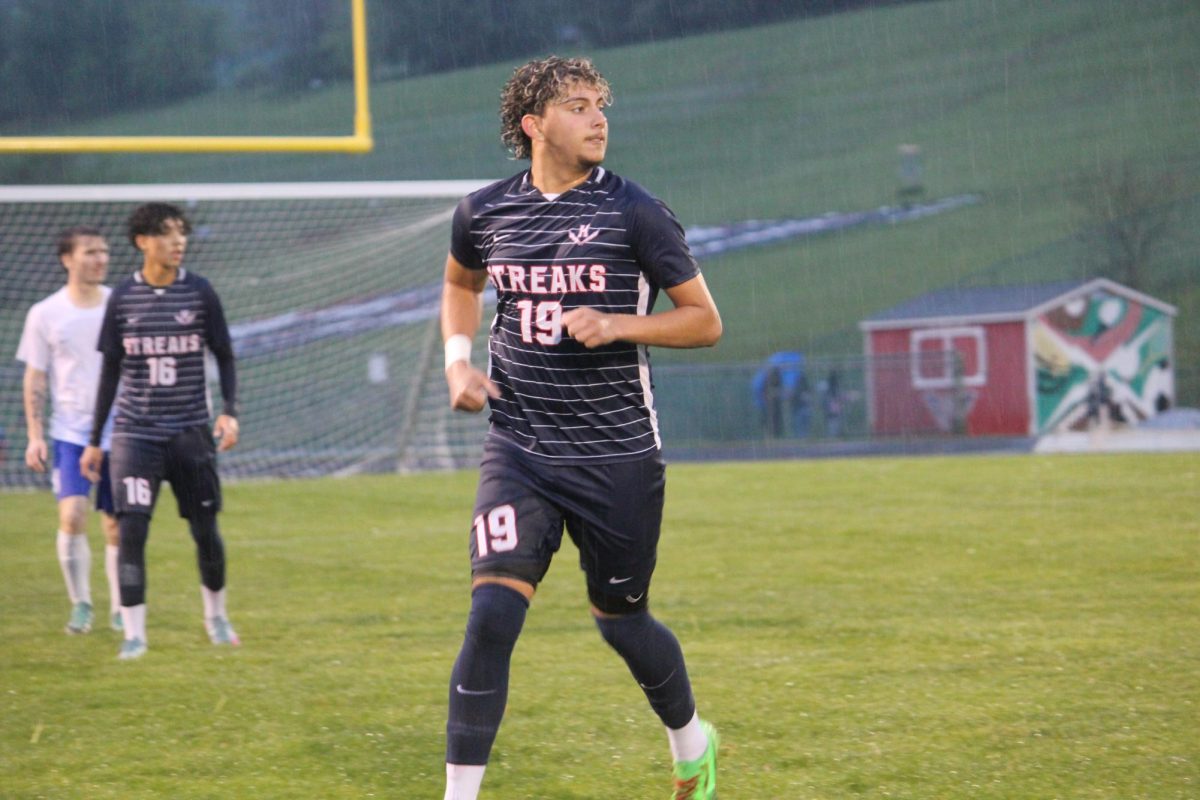 Senior Rayyan Garout running on the field.