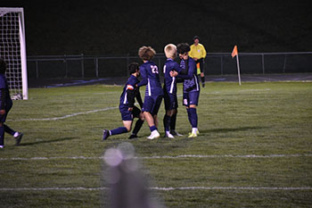 Junior Kaiden Velasquez assists Sophomore Izzack Gonzalez.
