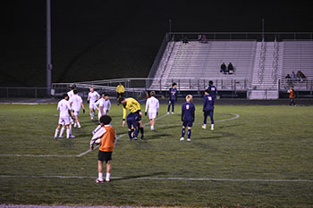Both HHS and opposing team preparing for free kick in opposing team's goal.