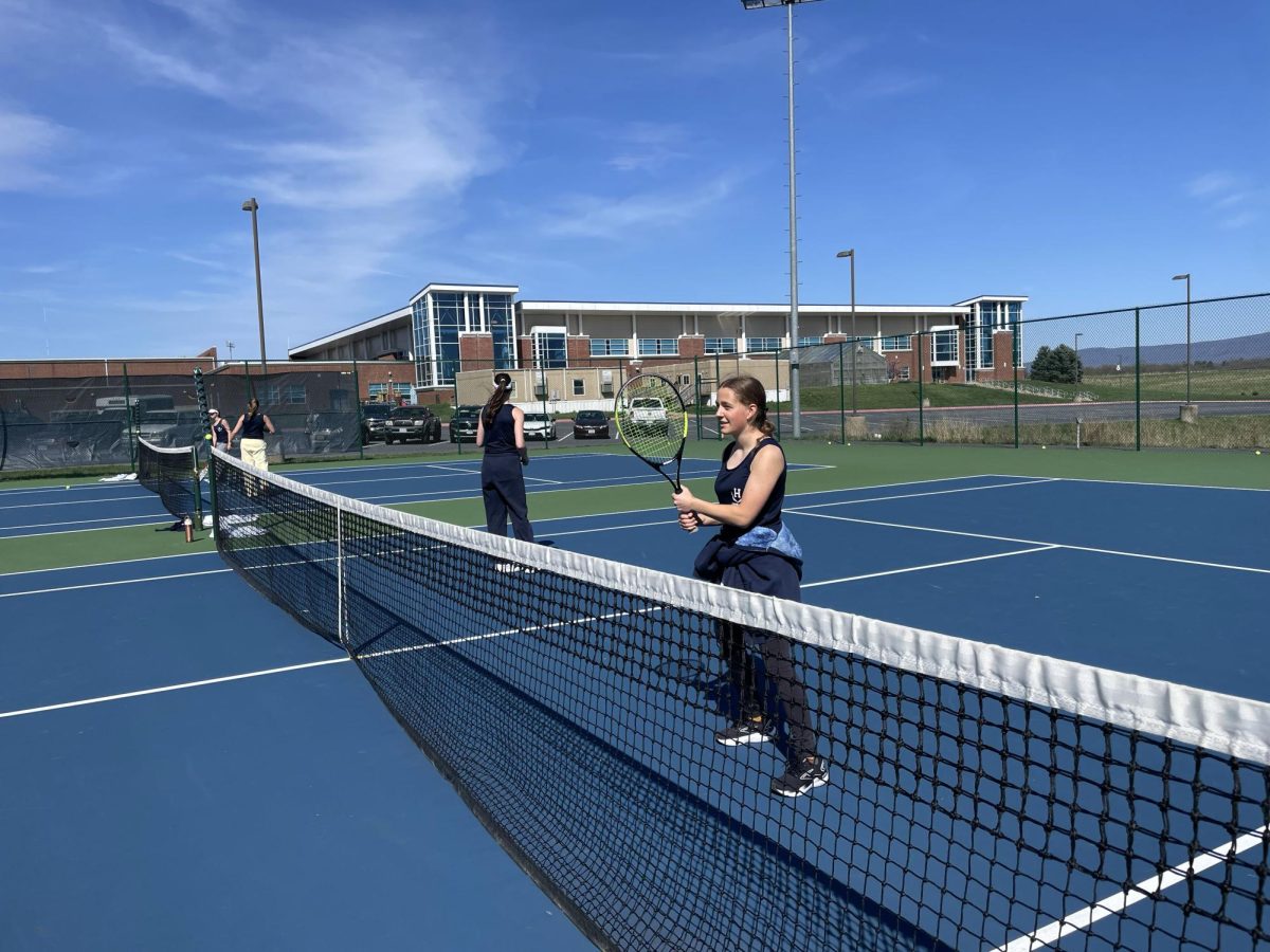 Junior Sylvia Young volleys the tennis balls. 