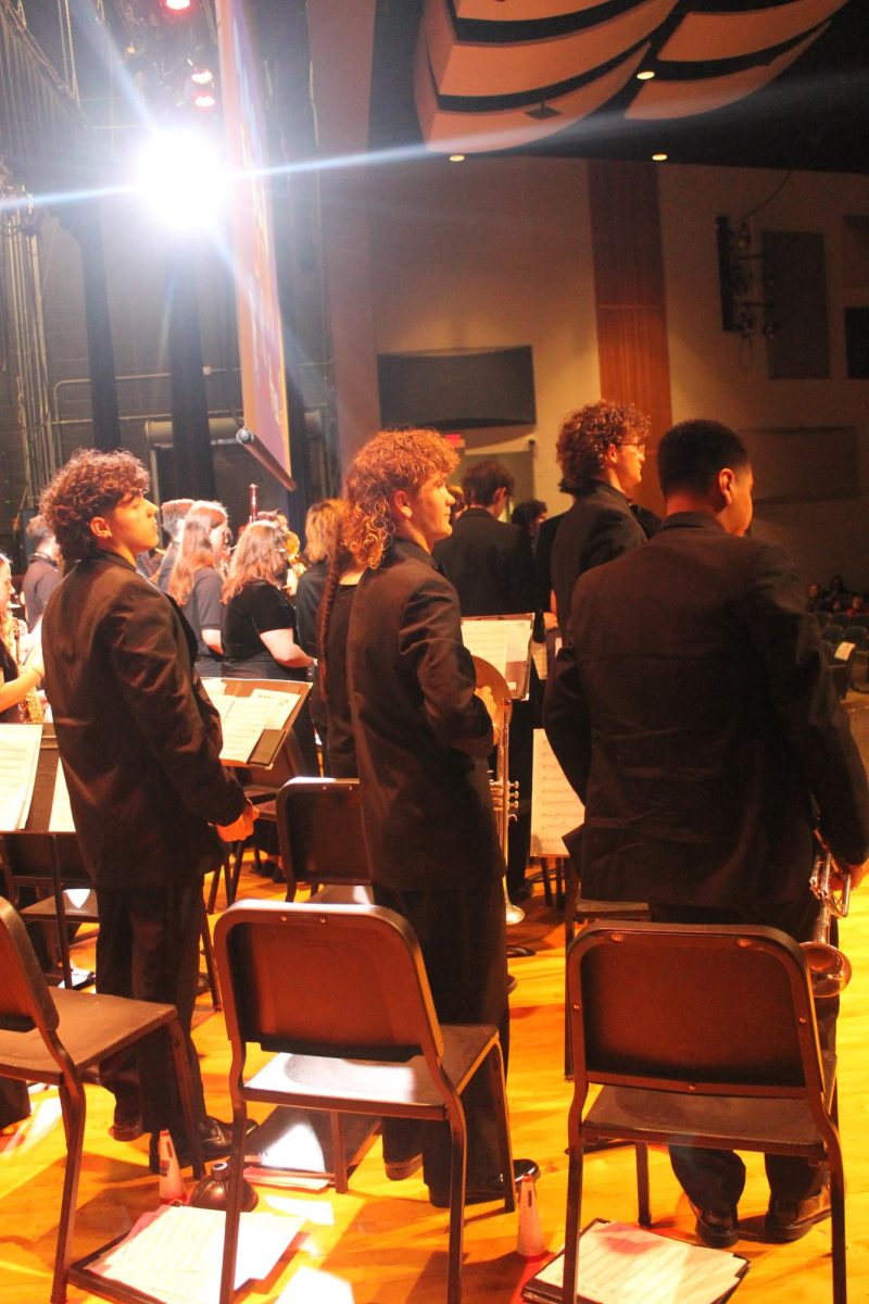 Students standing up after playing