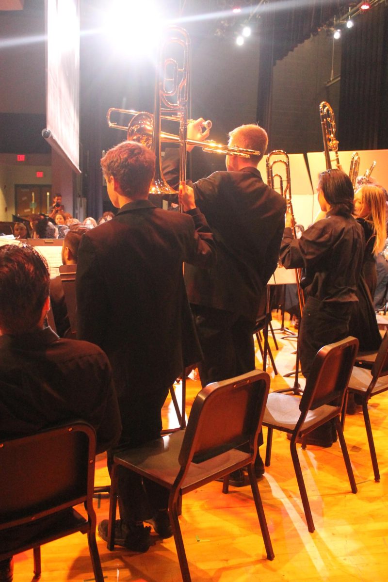 The trombones showing their instruments to the kids 