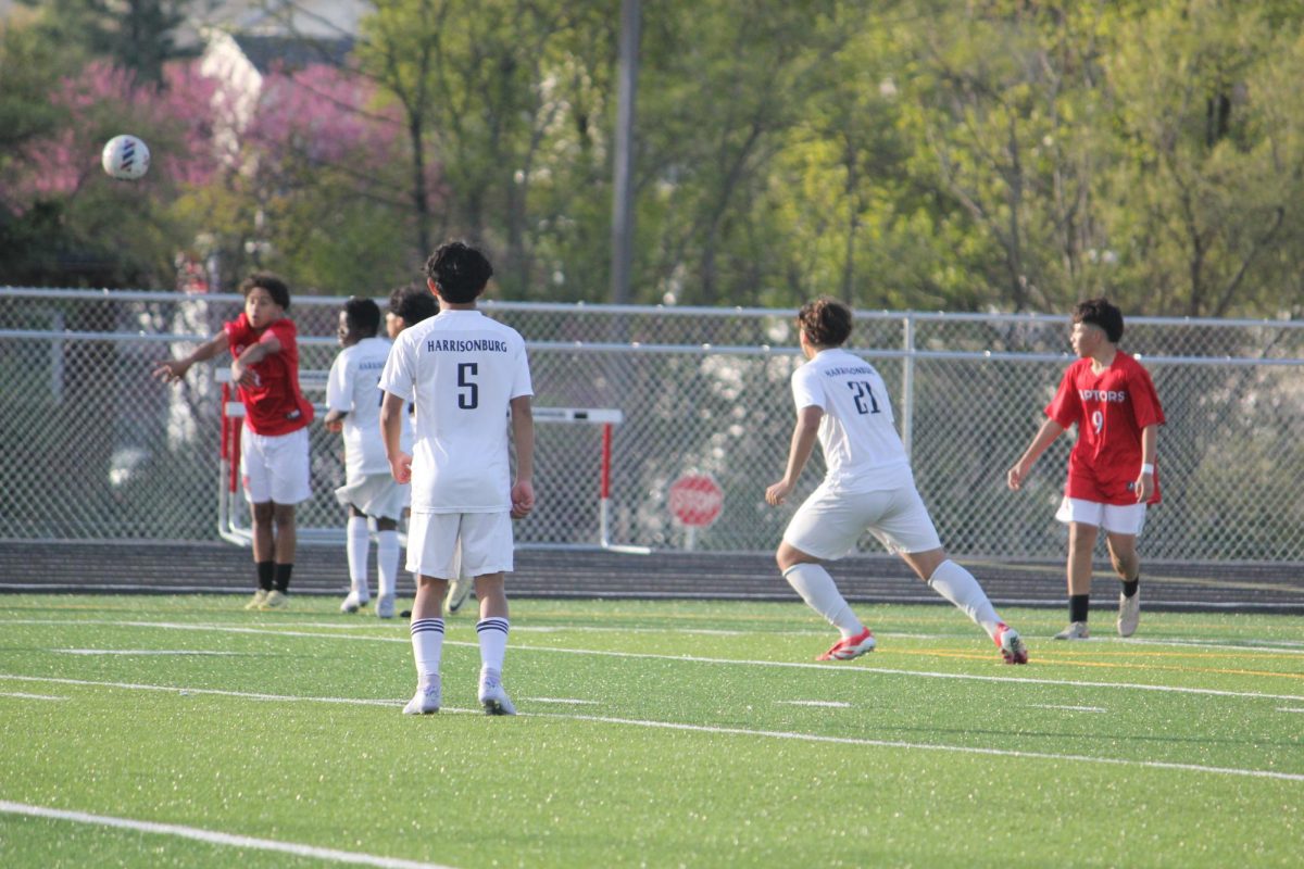 Jose Garcia and Jeferson Rivera standing on the field and eyes on the ball.