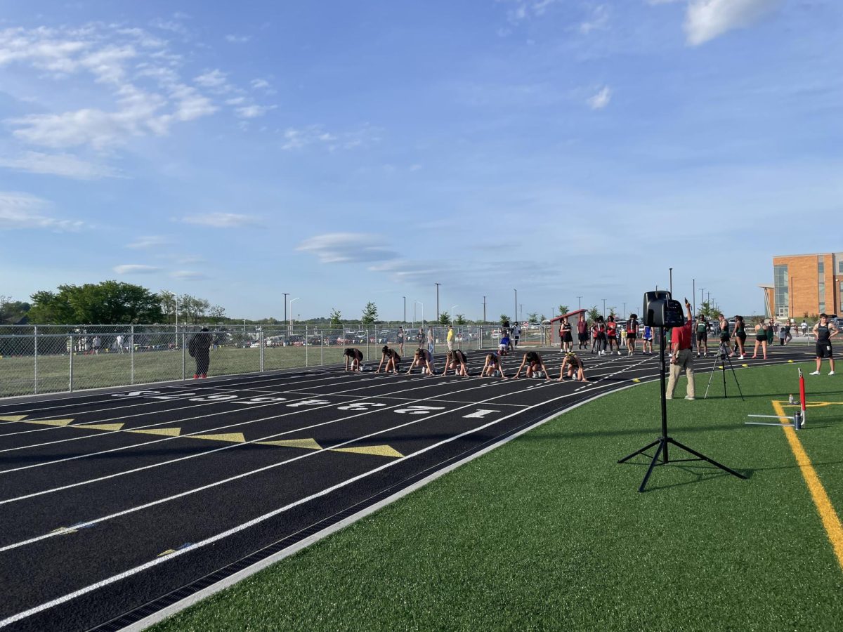 Athletes prepare to run the 100 meter. 