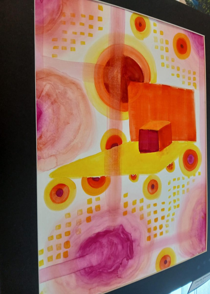 In one of Harrisonburg High School’s art classrooms, Jauan Brook showcases a student's impressive creation made from various shapes and warm, vibrant colors. The assignment focused on using as much color as possible, and the student excelled in achieving that goal. “She did well; I like the watercolor a lot,” Jauan Brook remarked.