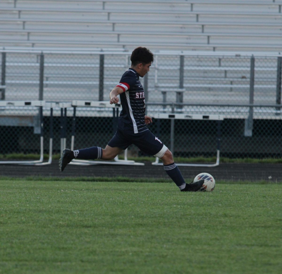 Senior Izaack Gonzalez about to kick the ball 