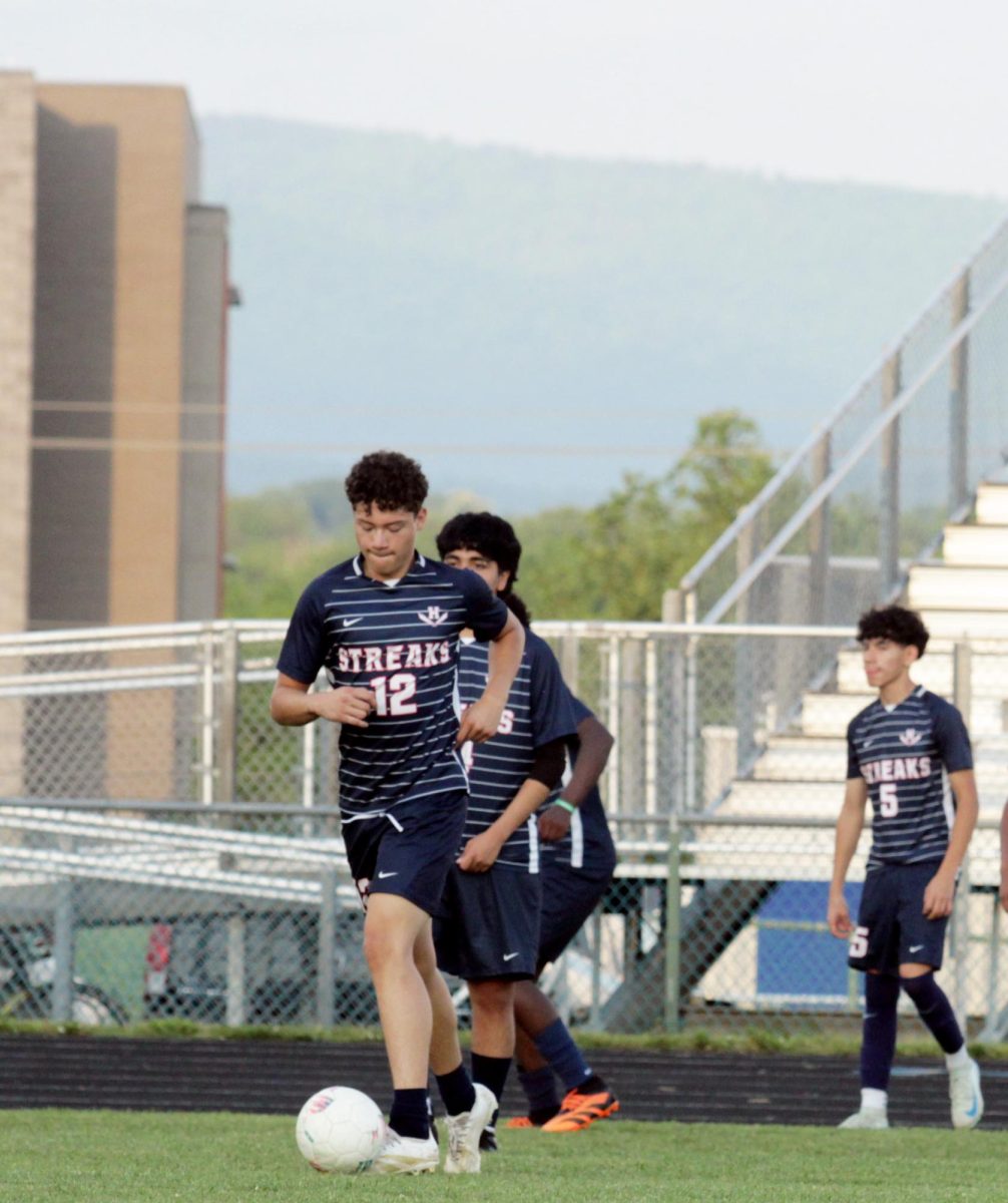 Senior Christ Galvez warming up before the game 