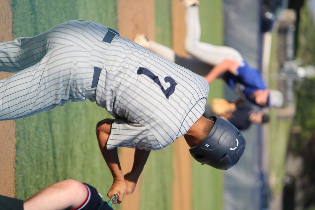 Senior Israel Cano is captured mid-swing, bringing years of experience and raw power to the moment. His form is sharp, his focus unshakable—every pitch is a chance to make an impact. A dependable force in the Blue Streaks lineup, Israel swings with purpose and pride.