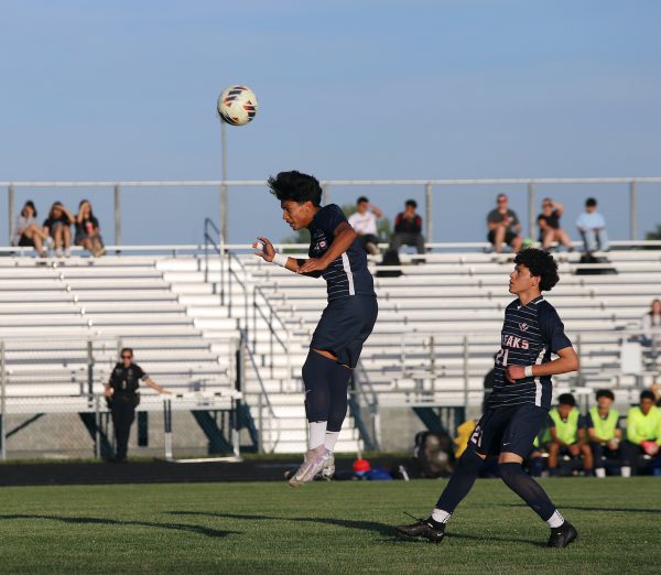 Freshman Andy Mendoza Flores heads the ball.