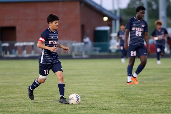 Senior Izaack Gonzalez dribbles down the field.
