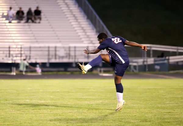 Junior Eritier Eca passes to a teammate across the field.