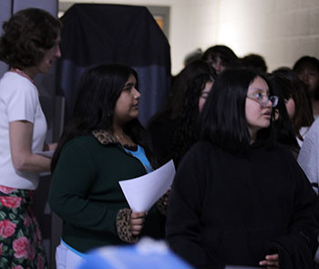 Eighth graders visiting the college fair are herded into the multipurpose room.