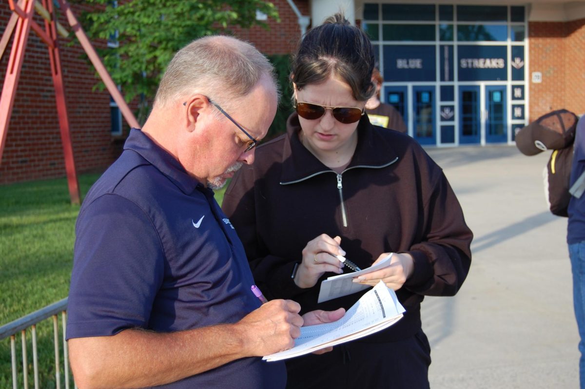 Mrs. Pittington checks off students for trip.